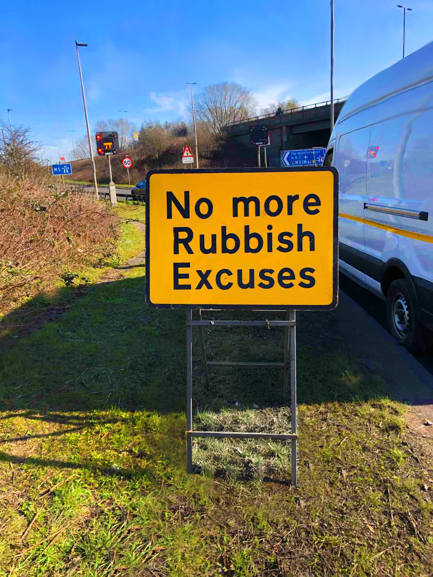 new road sign with the message "No more rubbish excuses' on a motorway verge